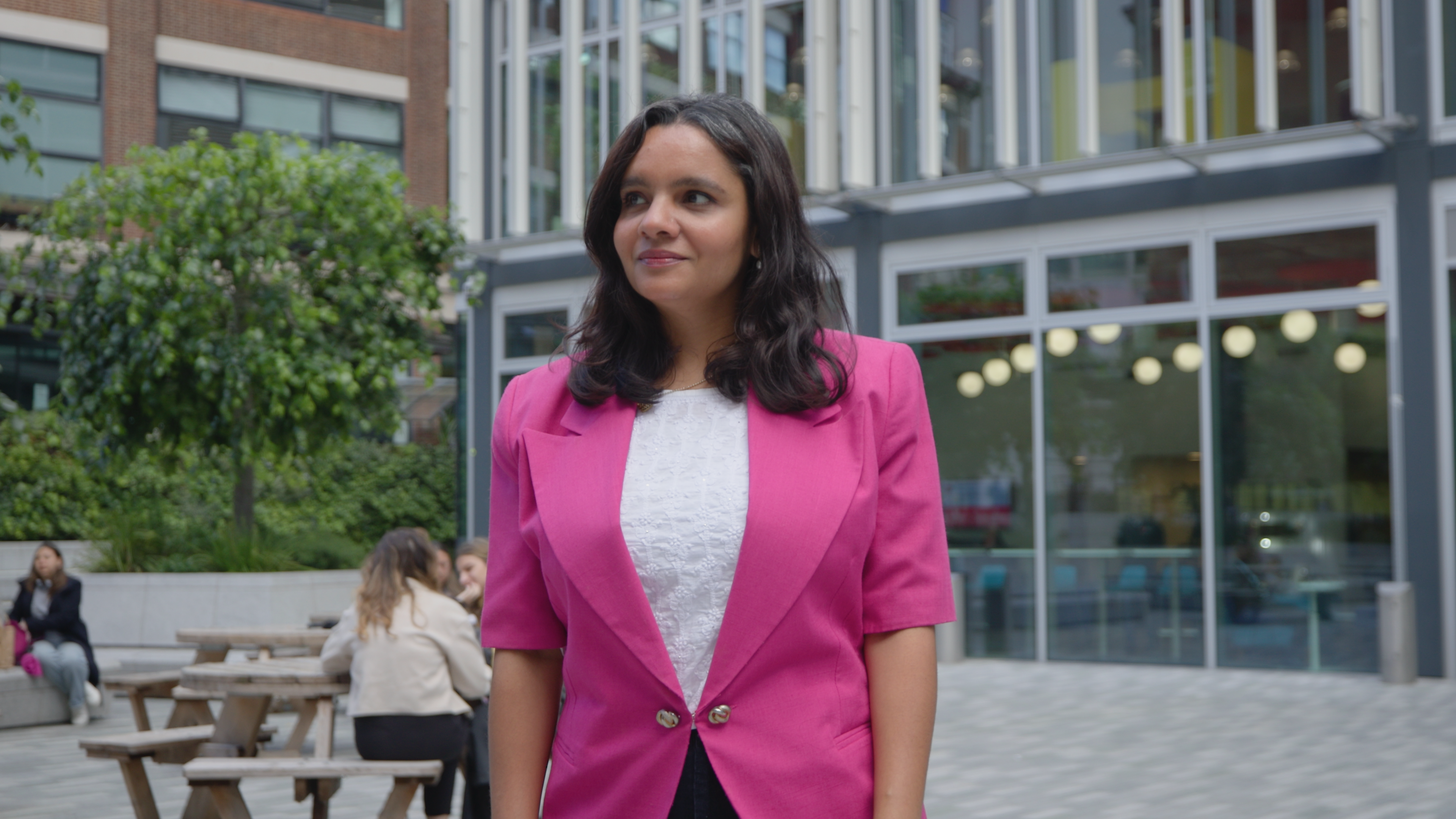 LSE alumna Anshu Choudhary smiling outside the Alumni Centre.