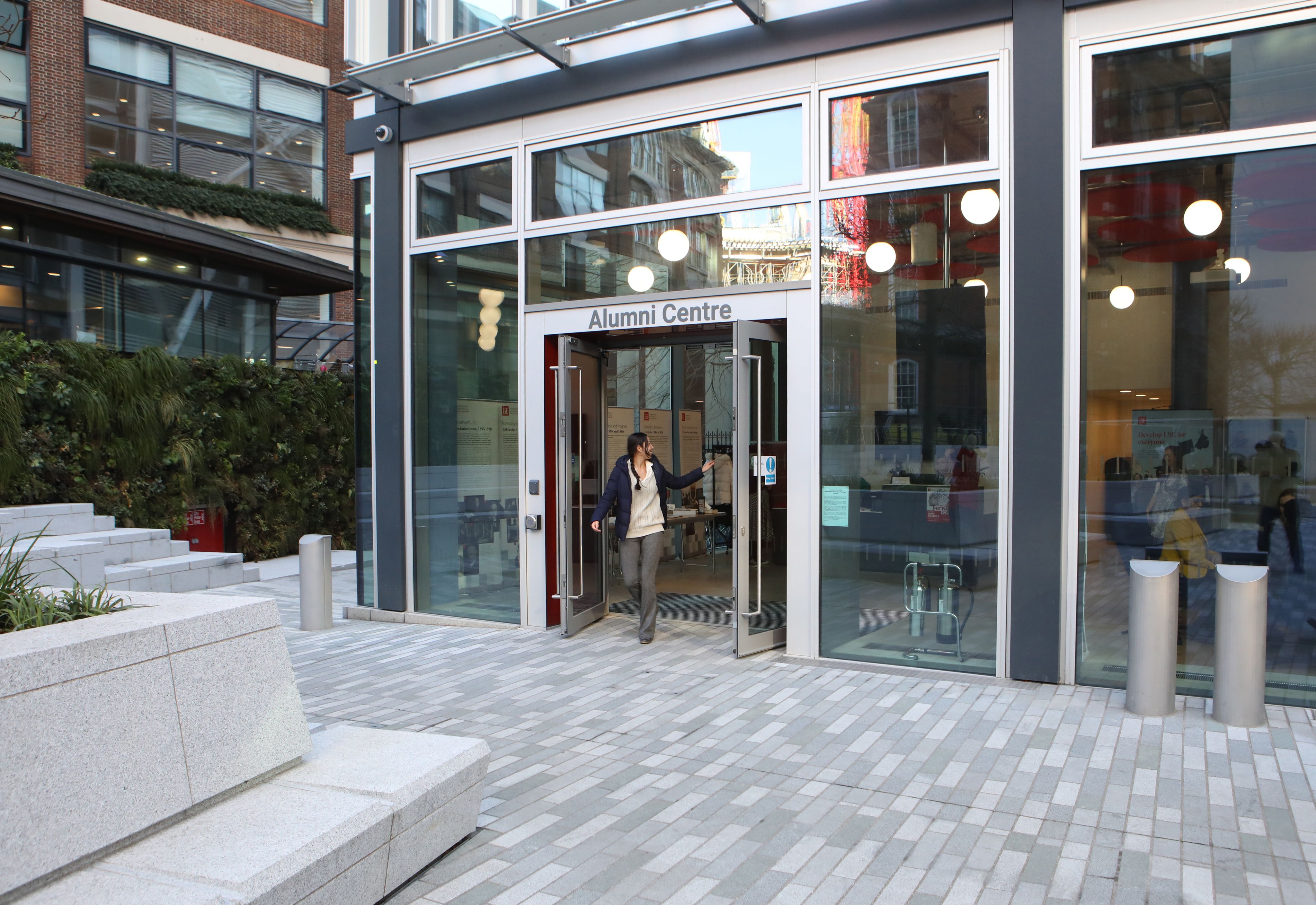 The front of the Alumni Centre with someone walking out the door
