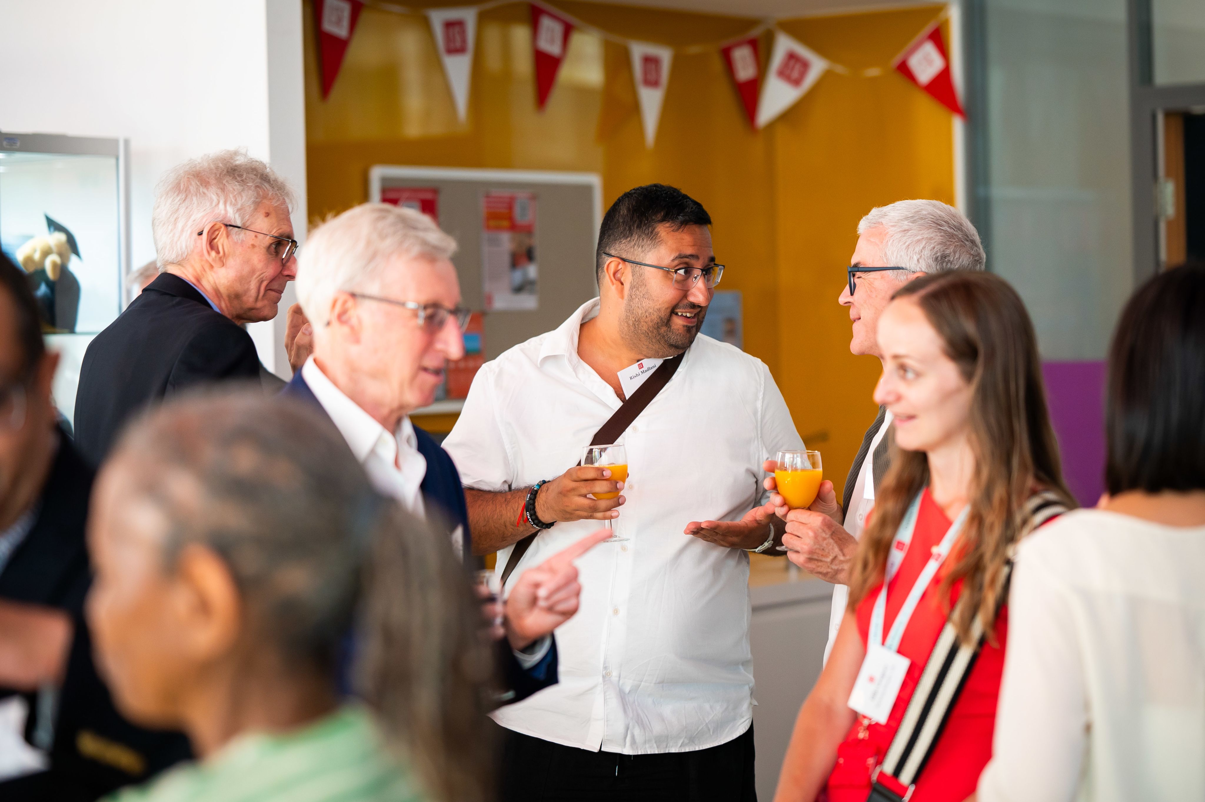 People talking to each other over reception drinks